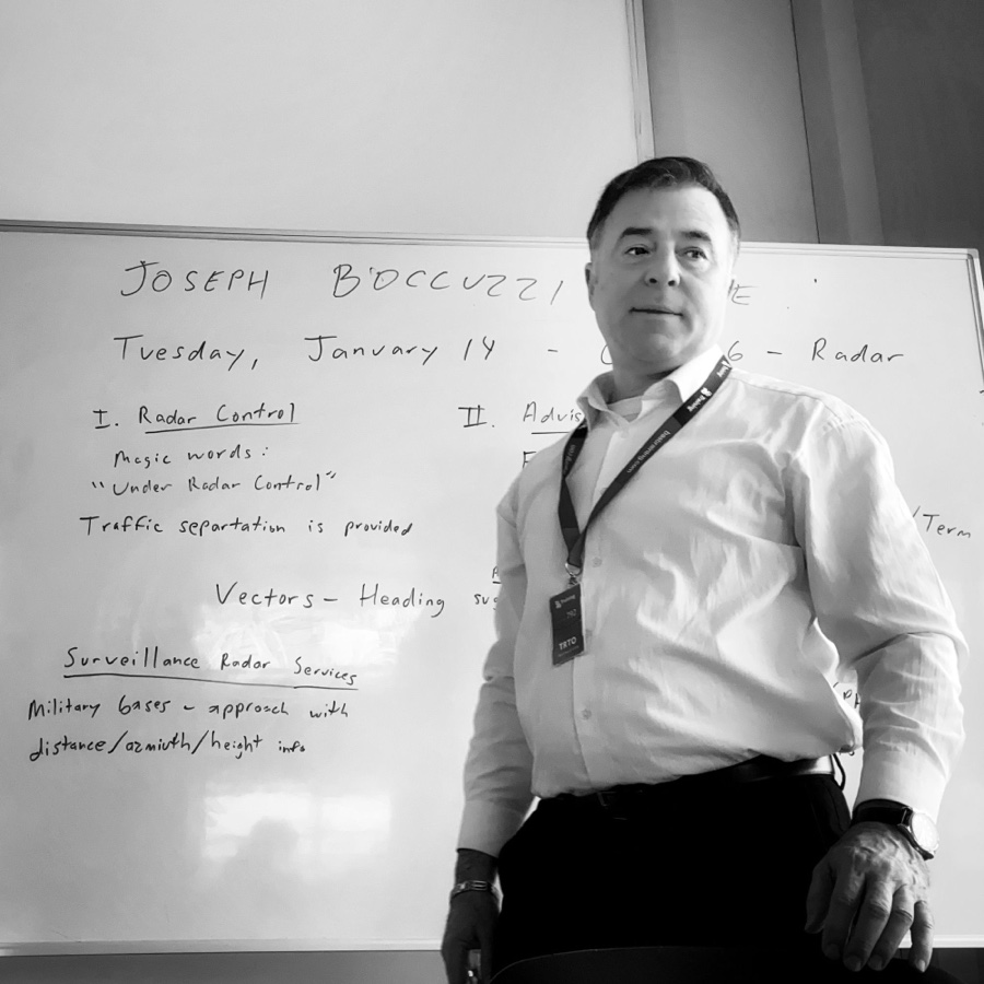 Joseph Boccuzzi in front of a radar-control briefing board